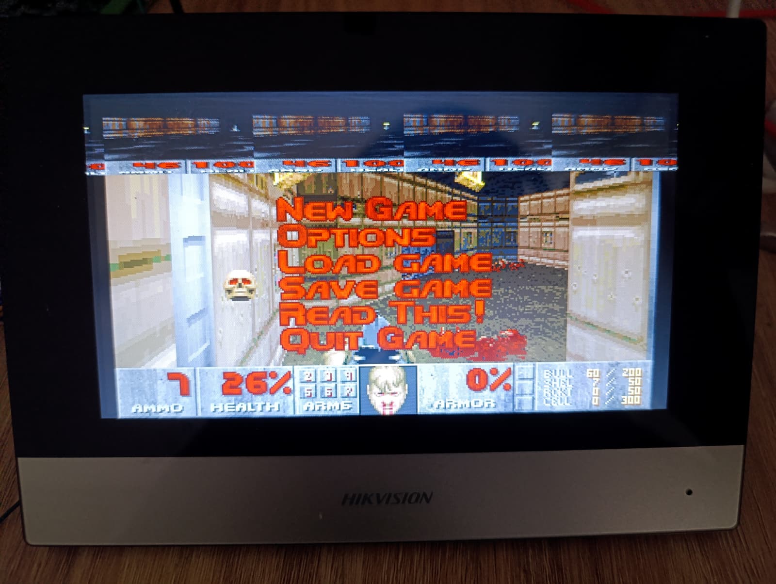 DOOM running on the DS-KH6320-WTE1 indoor station's touchscreen, full device in frame